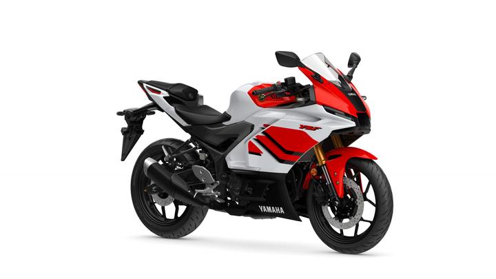 Yamaha 2026 R3 Anniversary Edition A sleek, modern Yamaha motorcycle with a white and red color scheme, featuring sport bike styling, a fairing, and a prominent front headlight.
