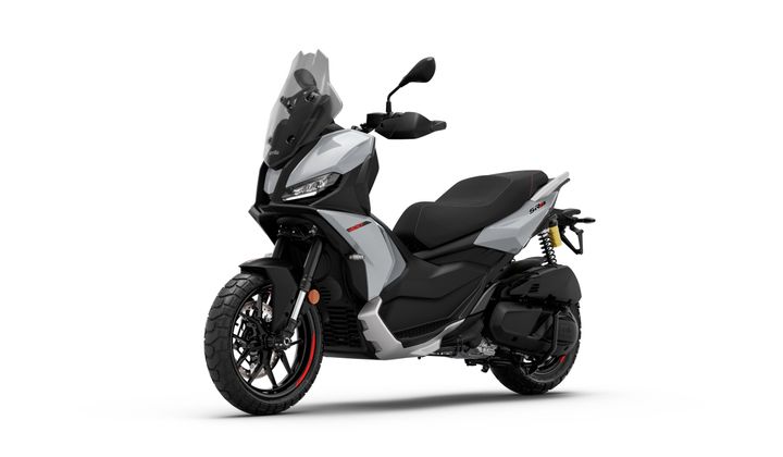 A sleek gray scooter with sleek lines, black seat, and modern design, featuring a tall windshield, rearview mirrors, and rugged tires, positioned on a white background.