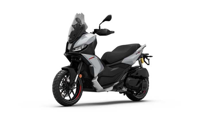 A sleek gray scooter with sleek lines, black seat, and modern design, featuring a tall windshield, rearview mirrors, and rugged tires, positioned on a white background.