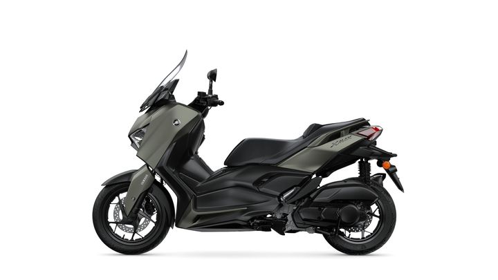 A sleek, modern scooter in a matte olive green and black color scheme, featuring a windscreen, dual headlights, and a sporty design, displayed from the side.