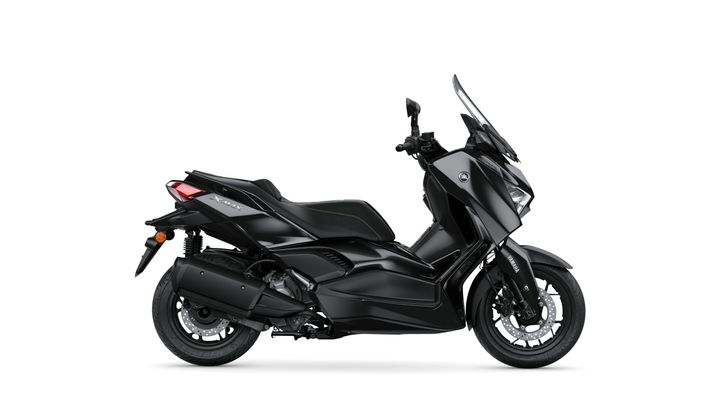 A sleek black scooter, Yamaha XMAX, is displayed from a side view, showcasing its modern design and features such as a windscreen and comfortable seat.