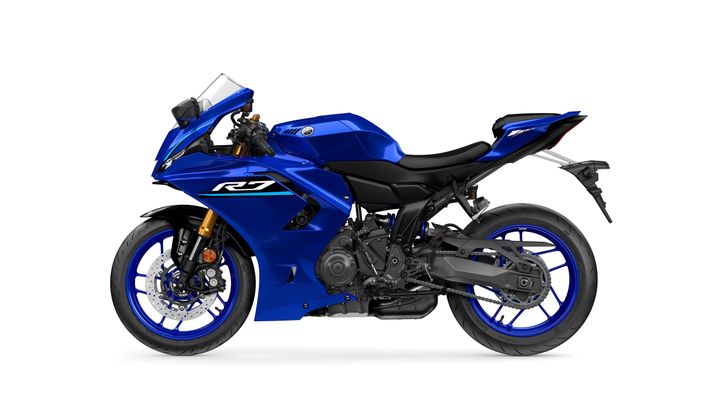 A blue Yamaha R7 motorcycle shown in profile view, featuring sporty design elements such as a fairing, racing seat, and racing wheels.