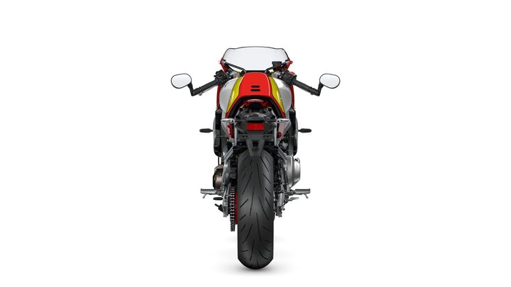 A rear view of a motorcycle with a distinctive red and yellow design, showcasing its aerodynamic shape, large rear tire, and dual exhaust.