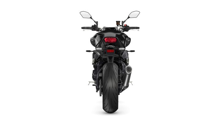 A black motorcycle viewed from the rear, showcasing its sleek design, prominent rear tire, and dual mirrors.