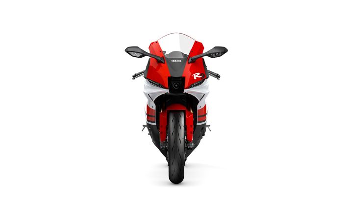 Front view of a Yamaha R9 motorcycle in red and white, showcasing its sleek design and prominent headlights against a plain white background.