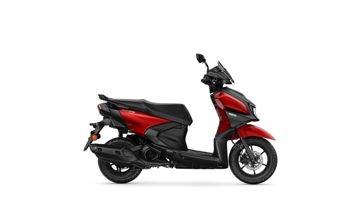 A red Yamaha scooter is shown from the side, featuring a sleek design with a black seat, front visor, and alloy wheels, set against a white background.