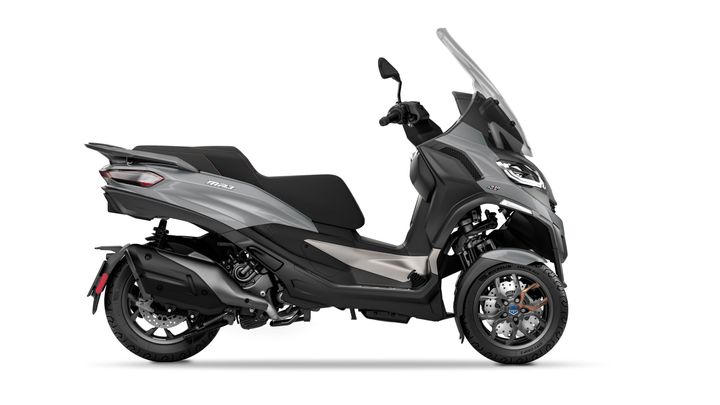 A sleek gray three-wheeled scooter showcasing a modern design, featuring a windshield, comfortable seating, and sport wheels.