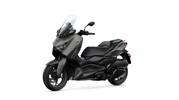 A sleek, modern scooter with a two-tone matte green and black design, featuring a tall windshield, large front wheel, and a comfortable seat.