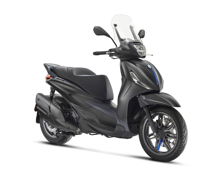A sleek black scooter with a windshield, showcasing a modern design and stylish detailing, positioned at an angle to highlight its contours and wheels.